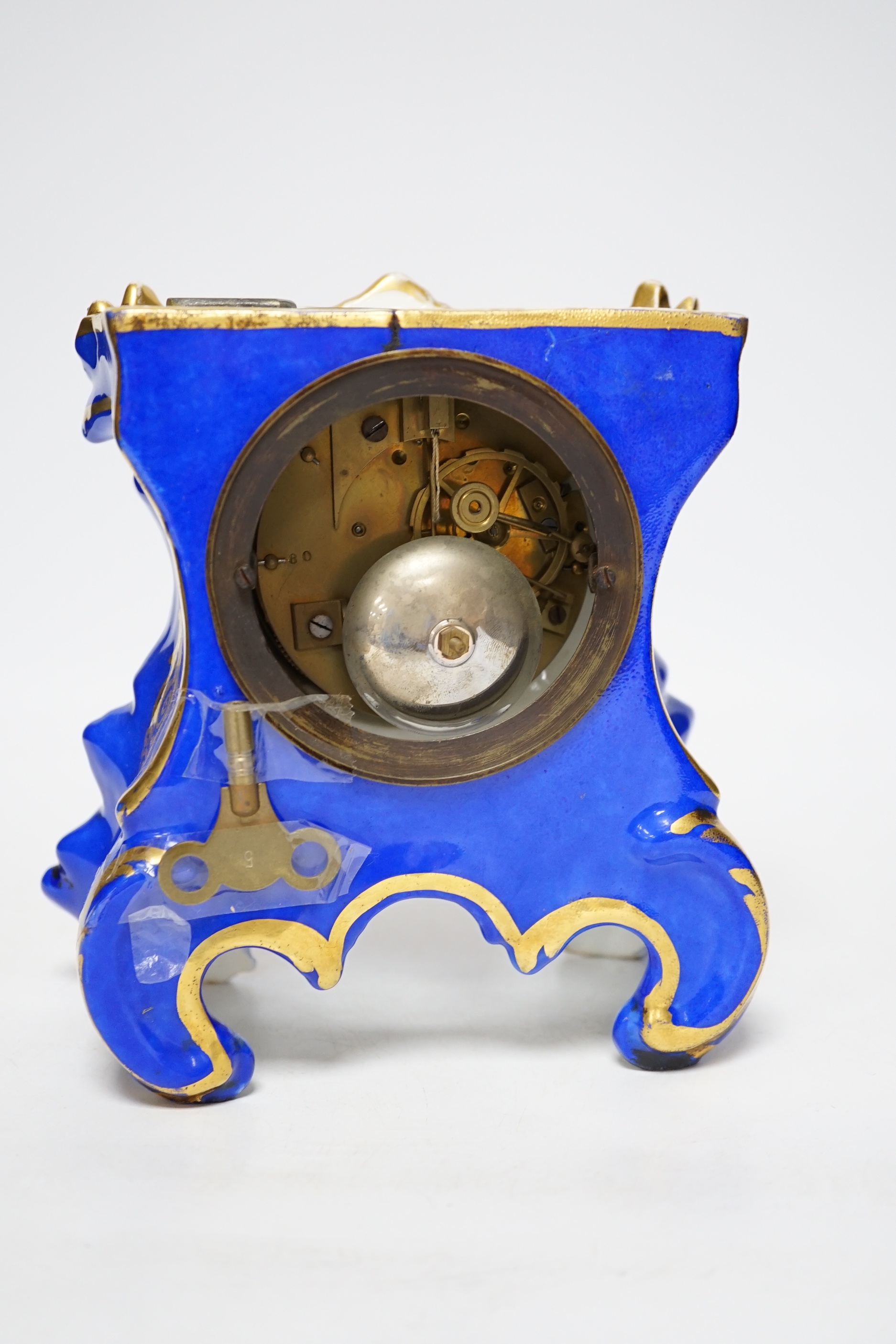 An early 20th century French porcelain mantel clock, missing top section, 19cm